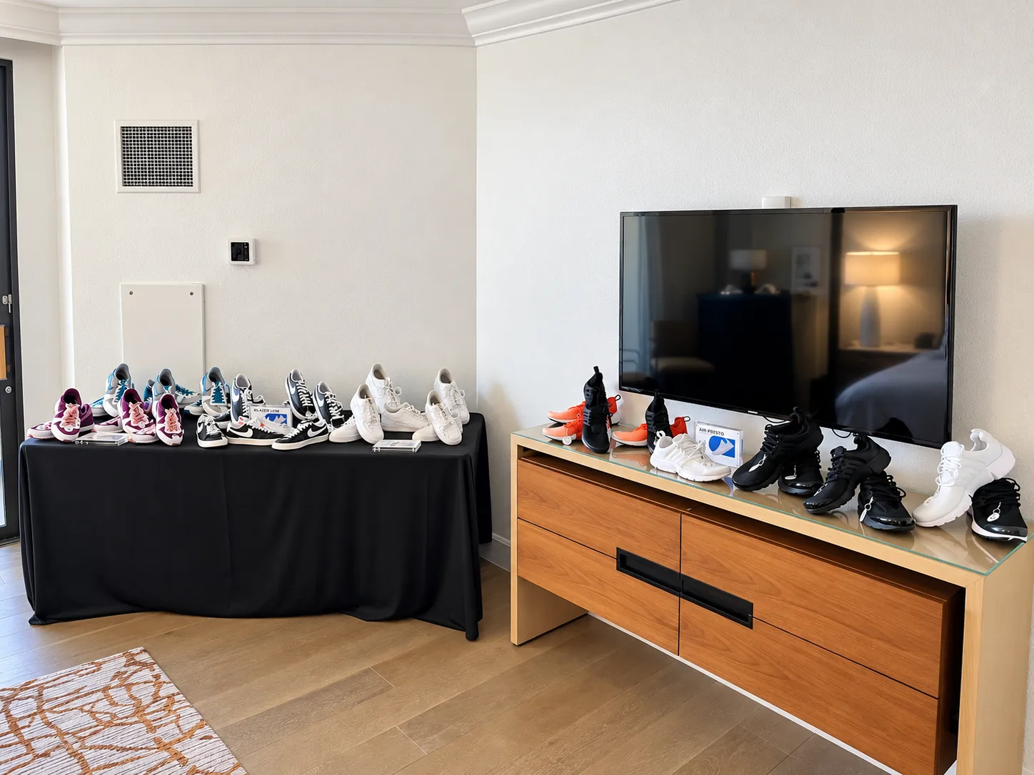 Sneakers lined up for customization on a table in the hospitality suite