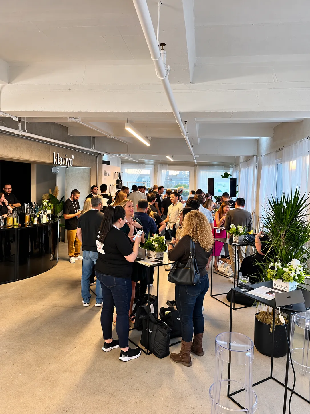 Guests mid-conversation at a crowded launch reception