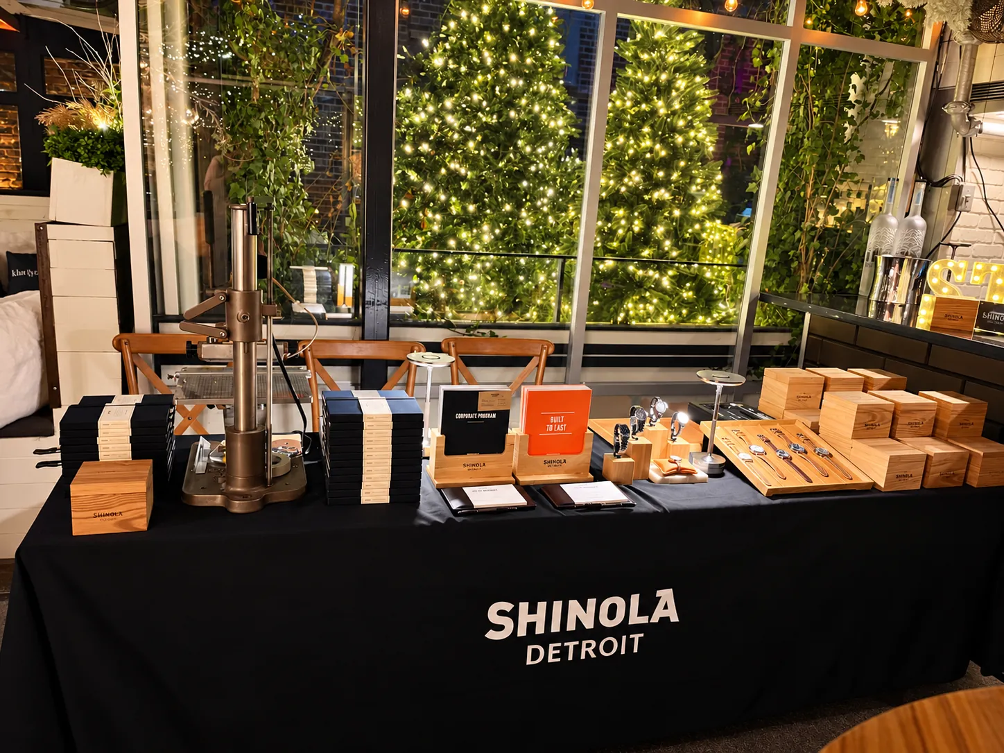 A watch customization station: straps, cases and tools laid out on a long table in warm light