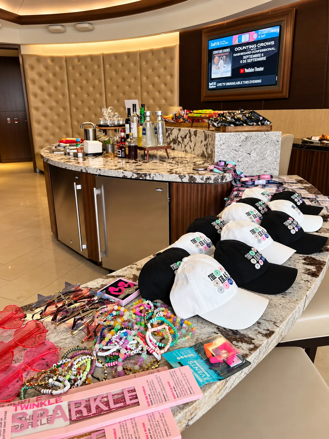 Custom caps, bracelets and gifts laid out on a counter in the suite